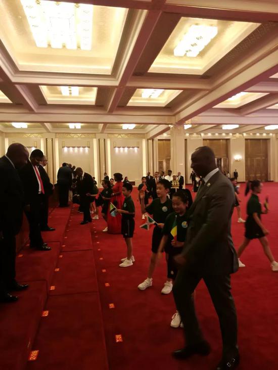 △手持各国国旗的小朋友引导领导人登上合影区（央视记者周志国拍摄）