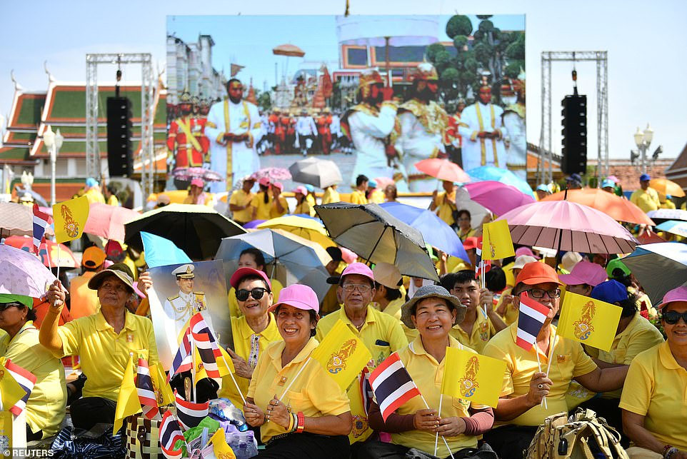 13111408-6994403-People_wait_for_a_coronation_procession_for_Thailand_s_newly_cro-a-93_1557055518445.jpg
