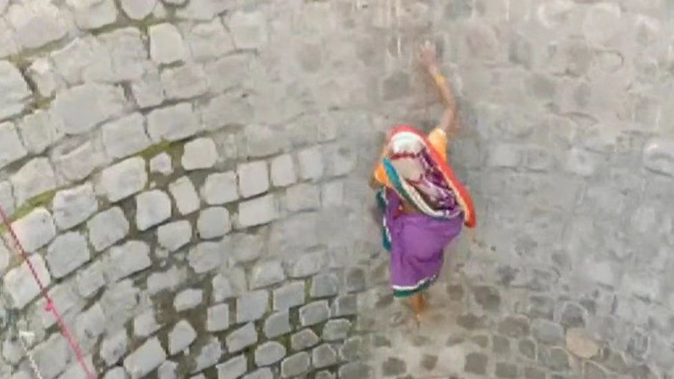 印度女子徒手爬井取水（图源：亚洲新闻国际通讯社报道截图）