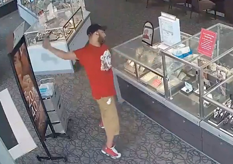 美国一名男子用砖头多次猛砸珠宝柜（视频截图）