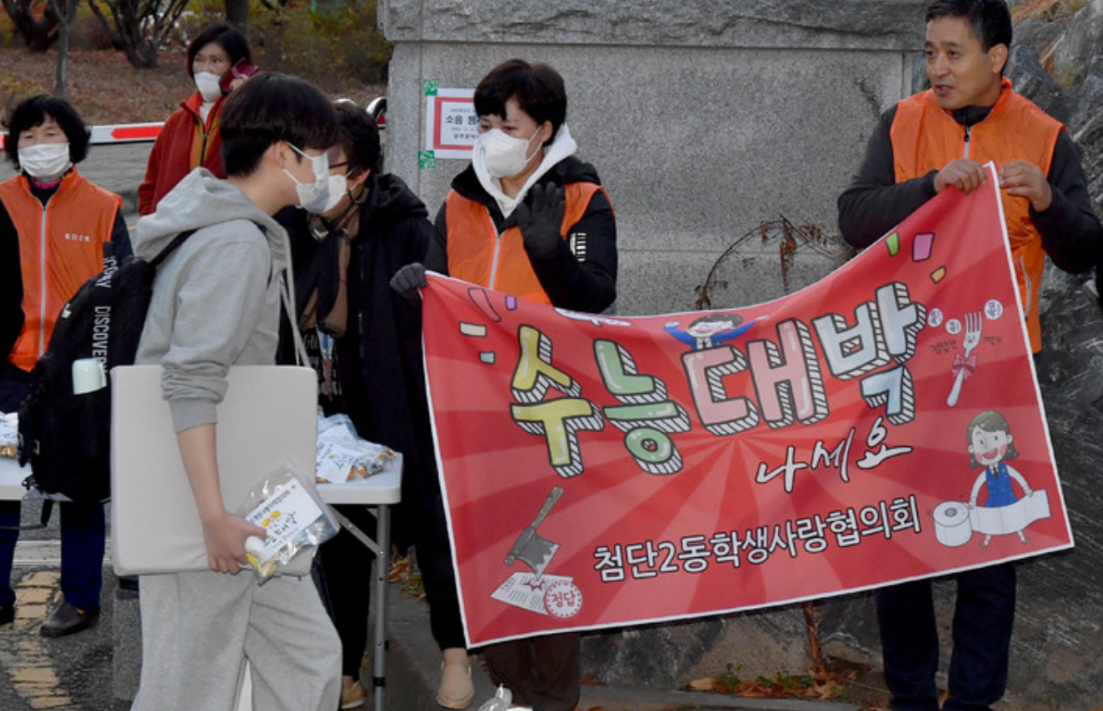 11月17日，韩国民众在考场外为考生加油打气。（纽西斯通讯社）