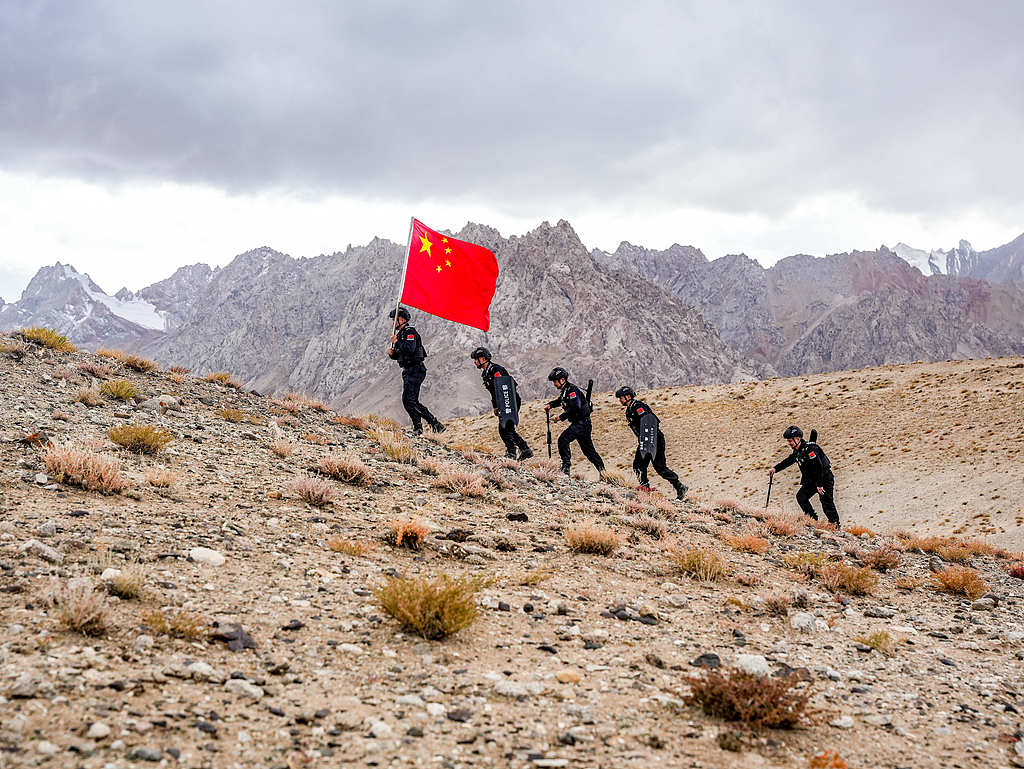 新疆喀什：民警手擎五星红旗巡逻边境