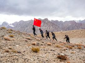 新疆喀什：民警手擎五星红旗巡逻边境